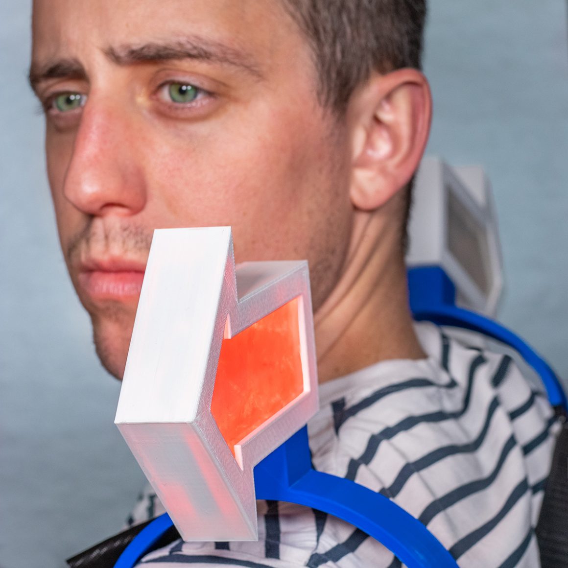 Matty wearing a shoulder-mounted indicator with a translucent orange panel.