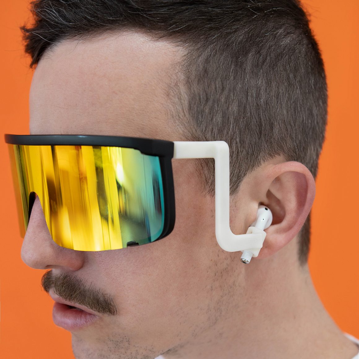 AirShades sunglasses with white arms connected to Apple AirPods in Matty’s ears.