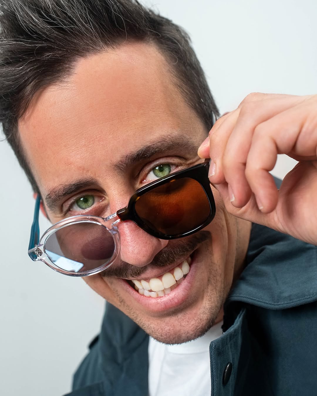 Matty wearing Frankenstein Frames with one round clear frame and one dark angular frame.